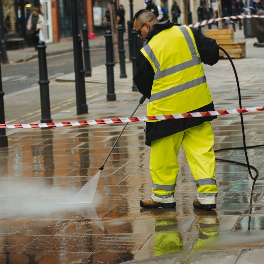Technician using a pressure washer wand on a hard surface